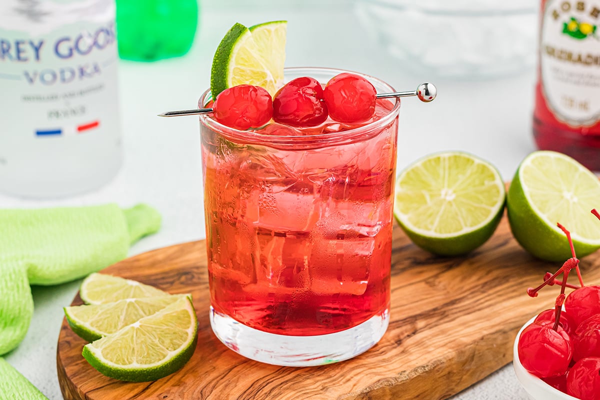 dirty shirley on a cutting board with limes
