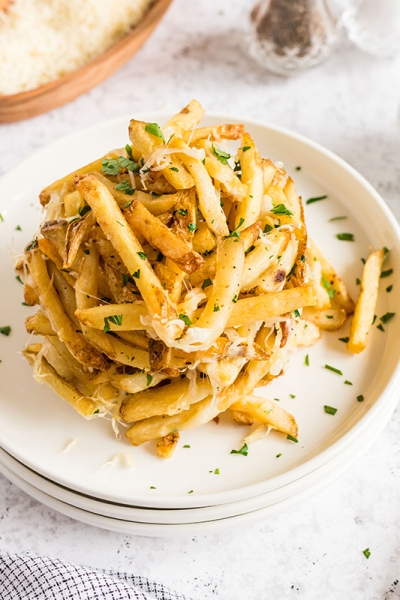 overhead shot of garlic cheese fries on two plates