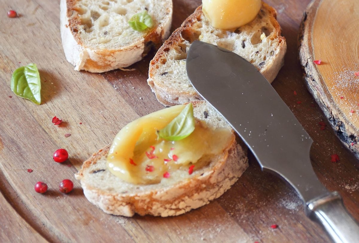roasted garlic clove on a piece of bread 