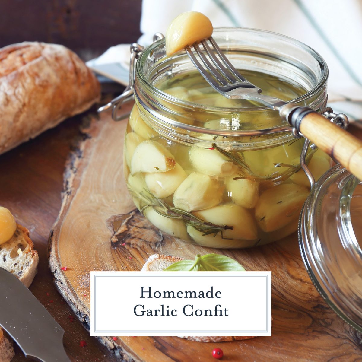 glass jar with clove of garlic on a fork 