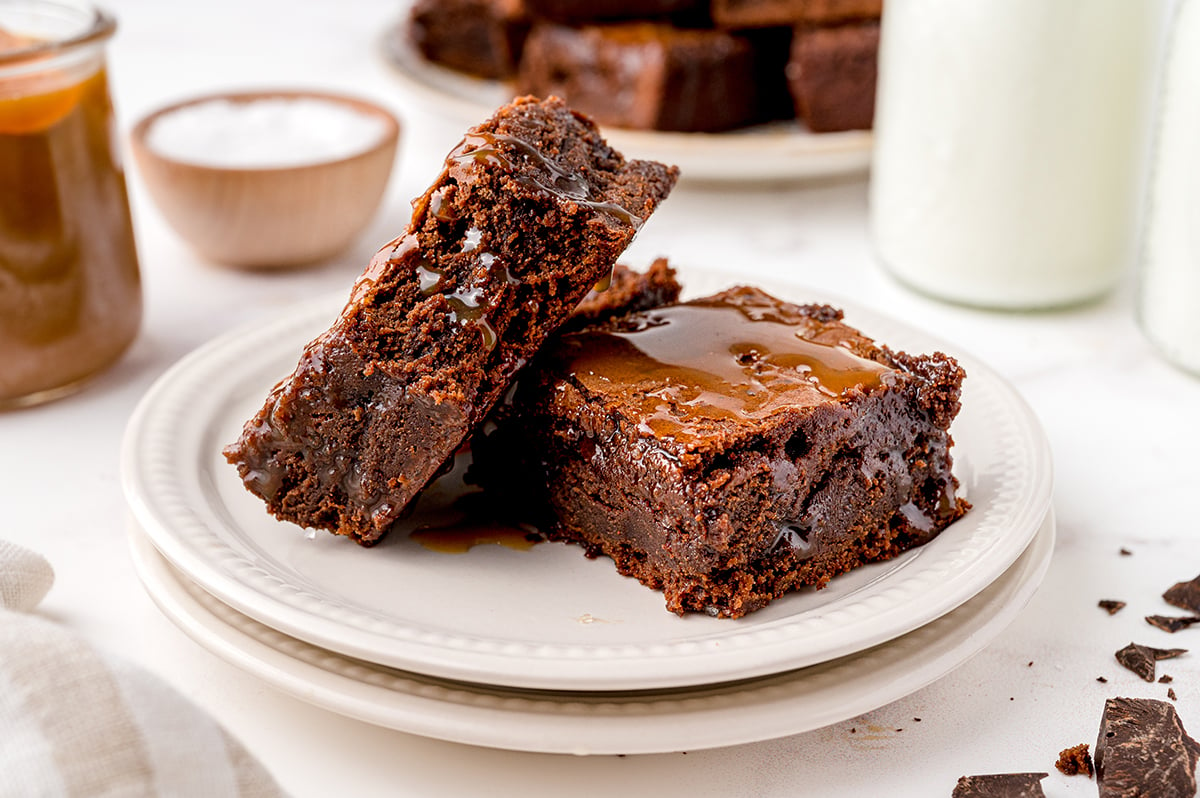 two brownies stacked on a serving plate 