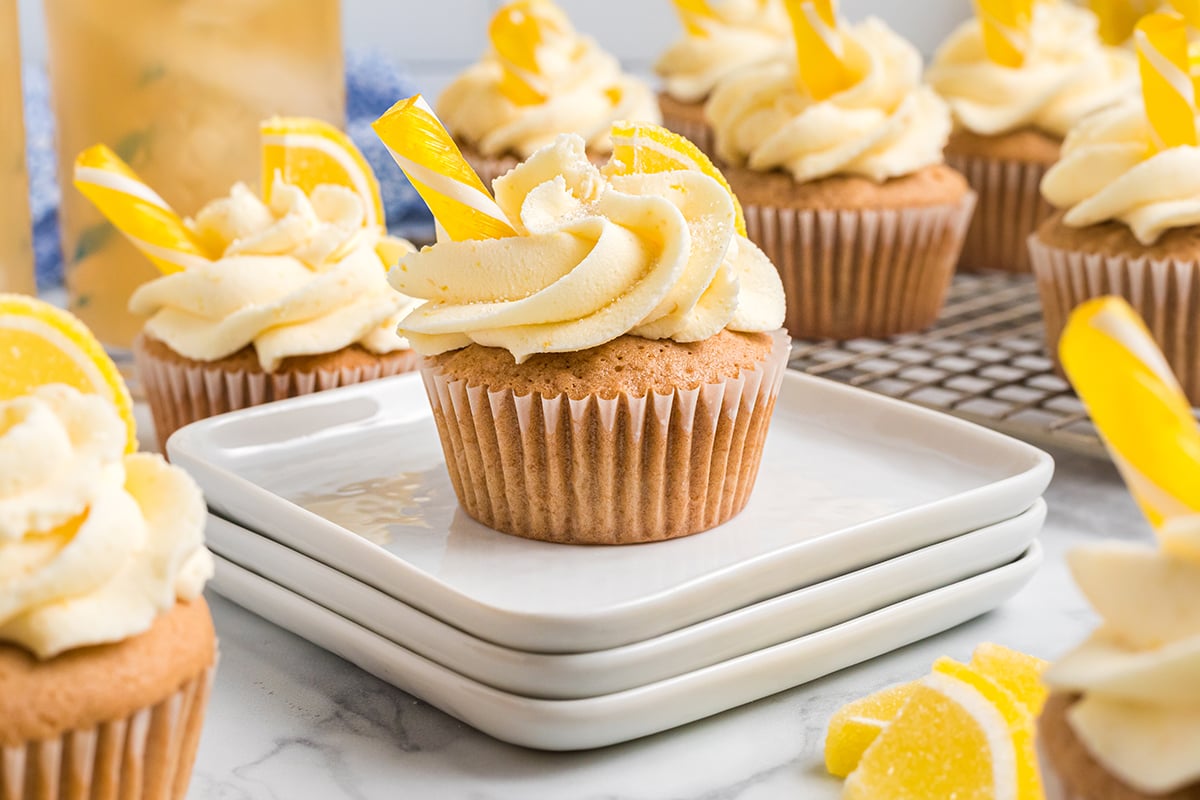 iced tea cupcake on a stack of white plates