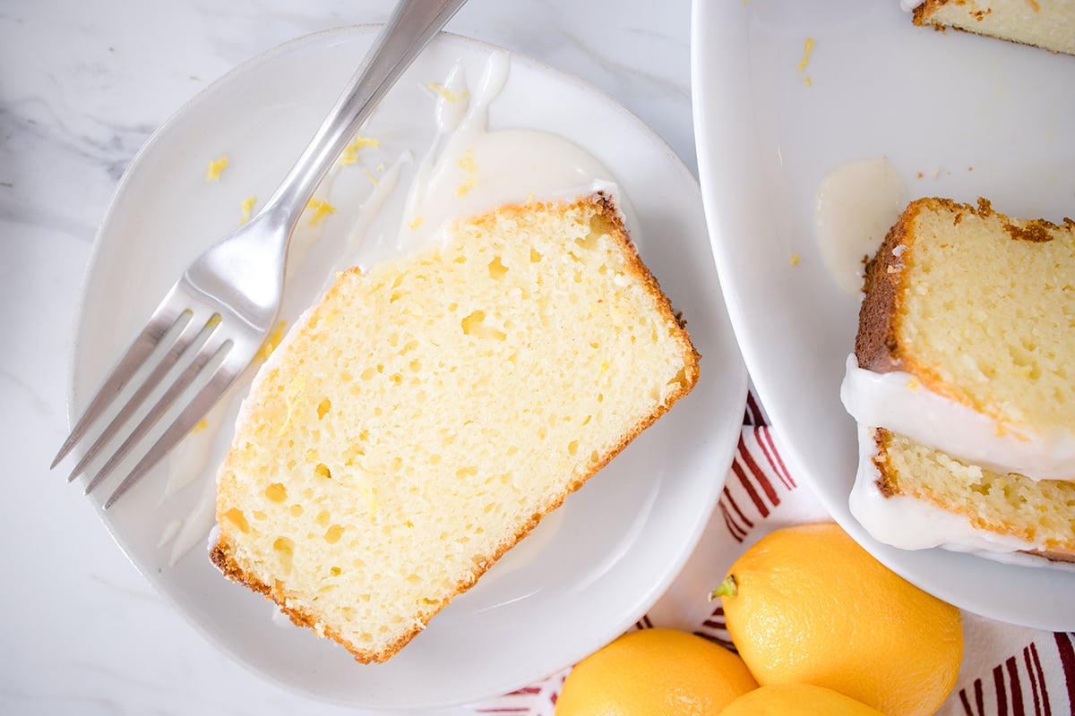 overhead shot of slice of lemon yogurt pound cake on a white plate
