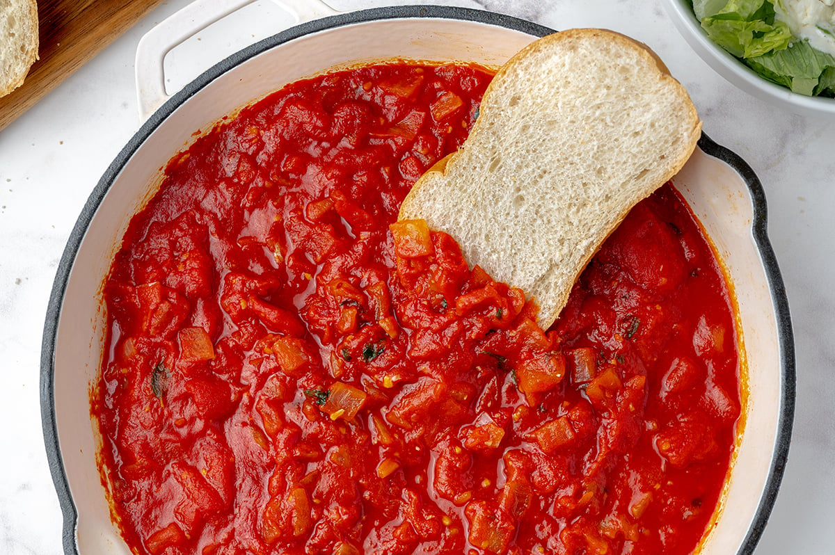 marinara in a pan with a slice of bread