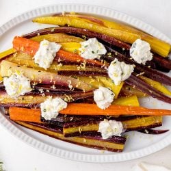 overhead platter of oven roasted whole carrots with white sauce