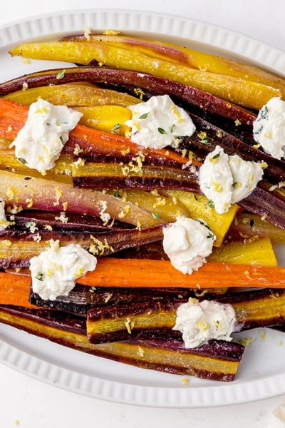 overhead platter of oven roasted whole carrots with white sauce