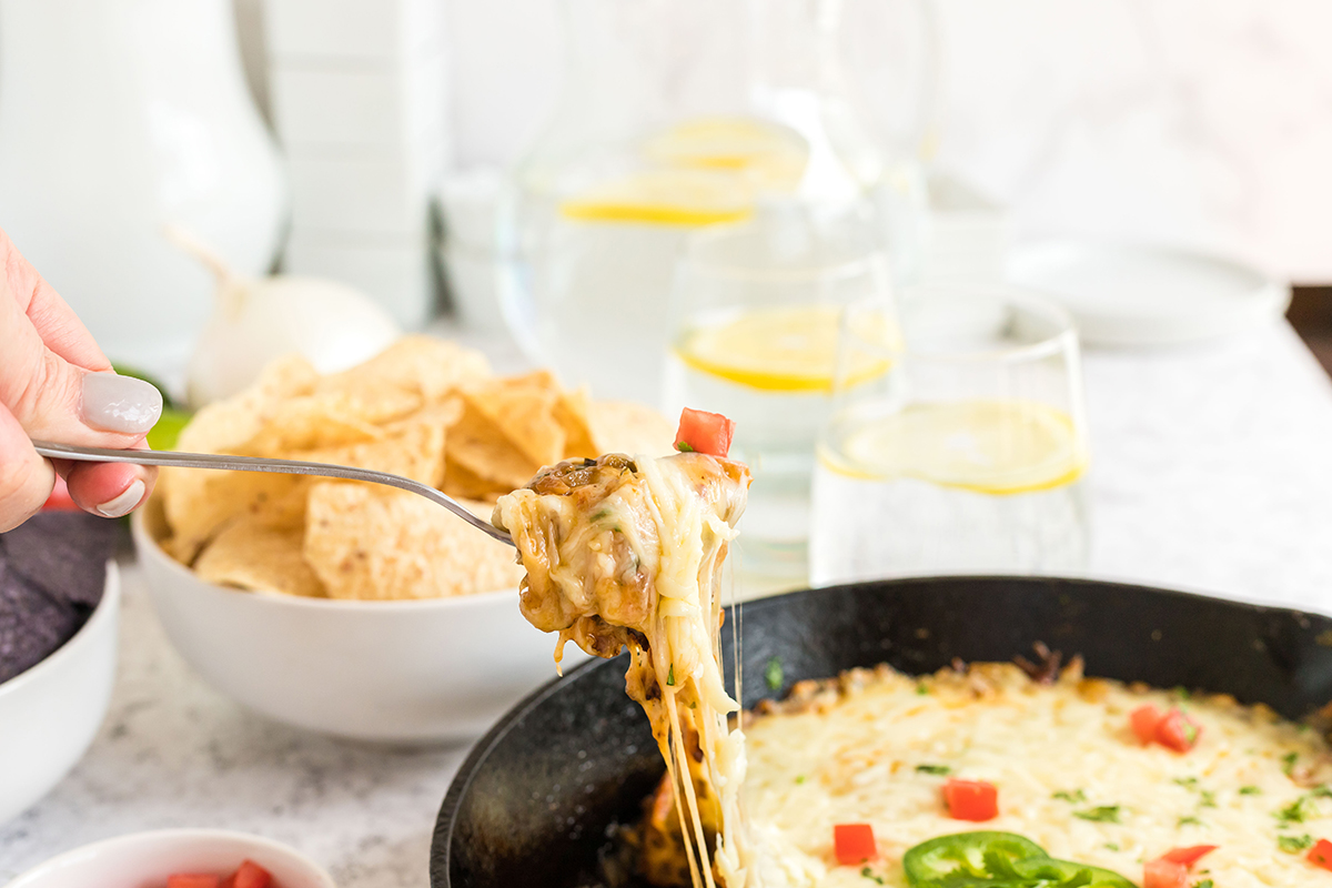 fork dipping into queso fundido