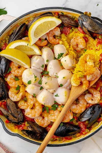 overhead of seafood paella recipe in a cast iron skillet