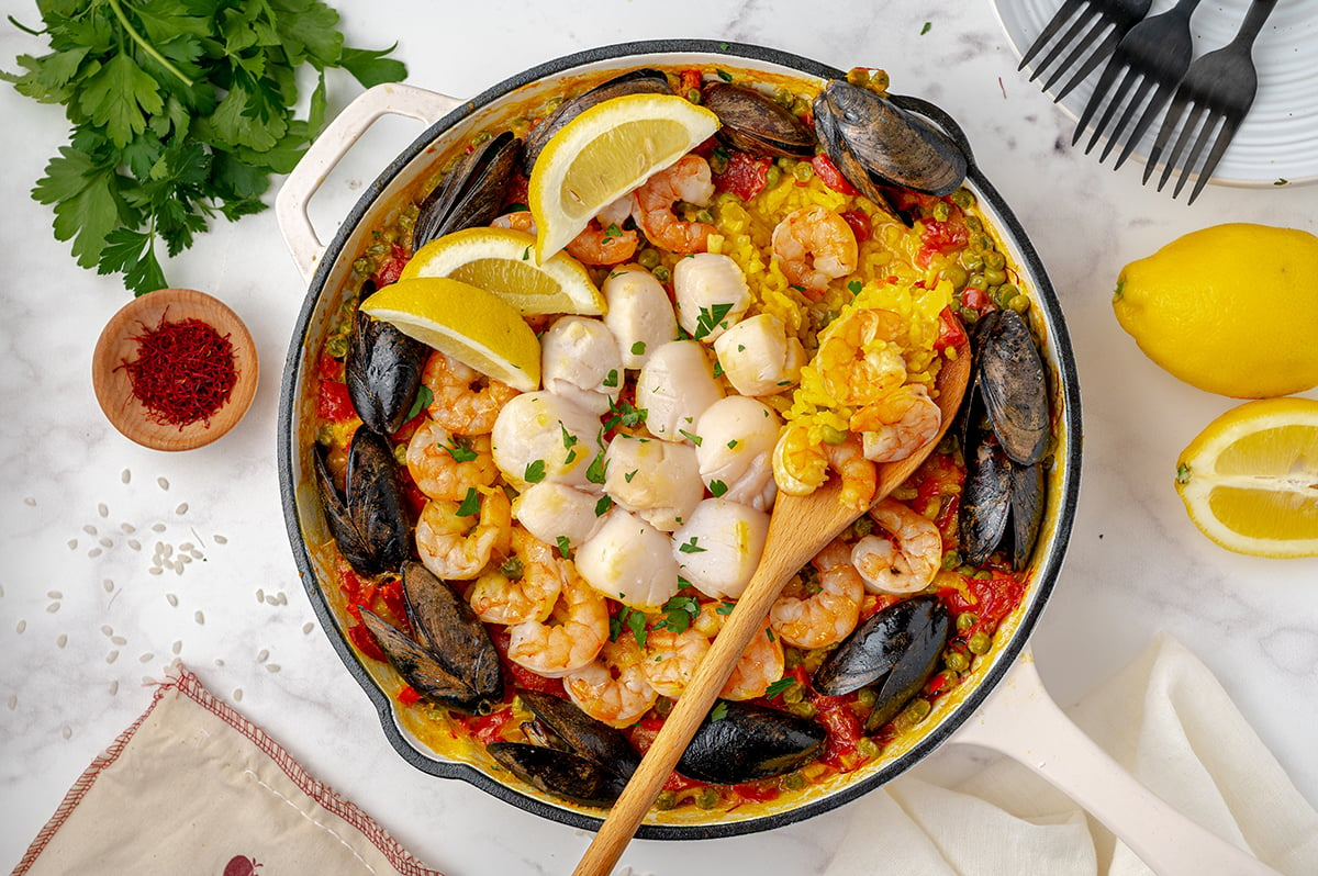 overhead of seafood paella recipe in a cast iron skillet