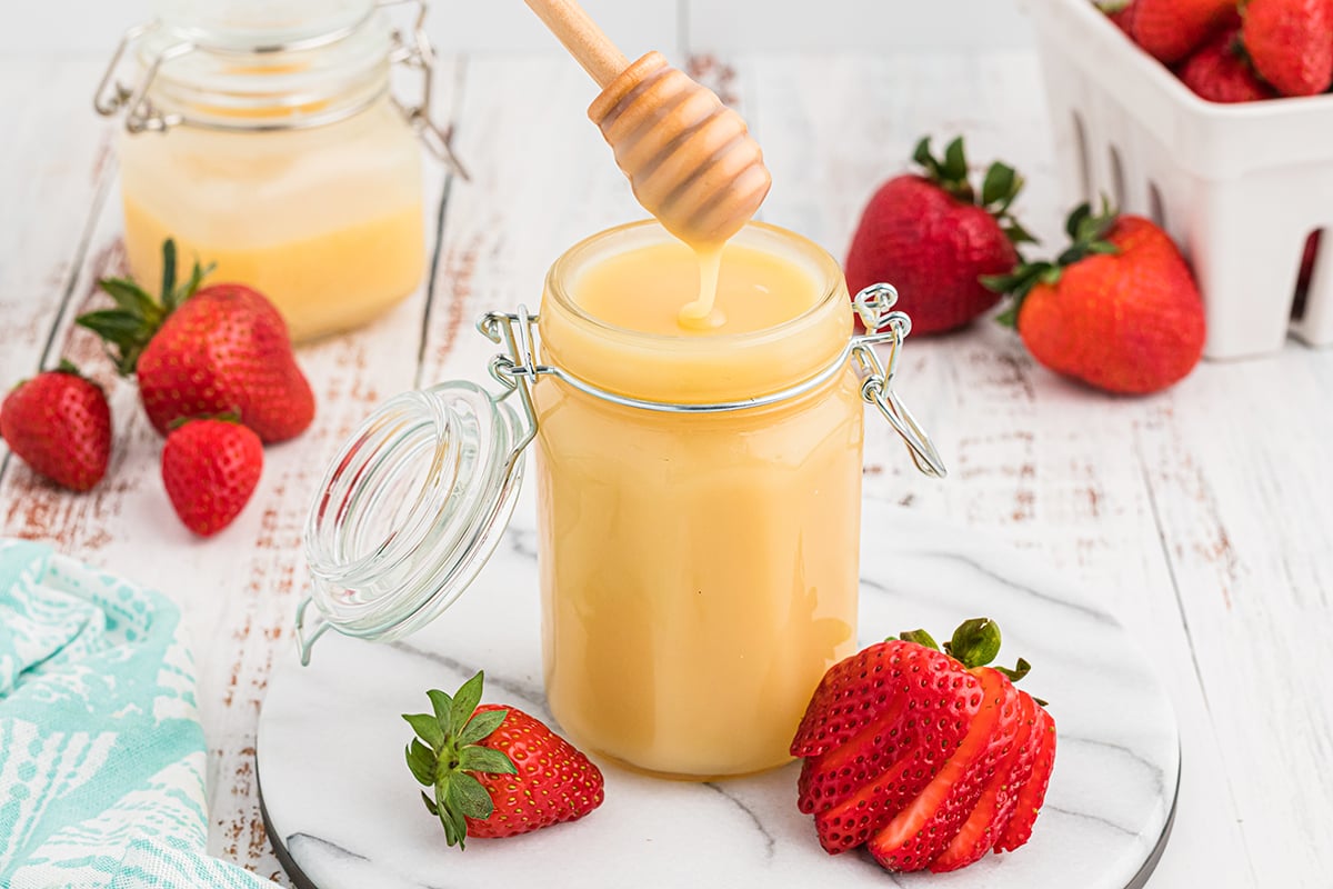 angled shot of honey stick in jar of vanilla butter syrup