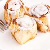 three cinnamon rolls on a plate