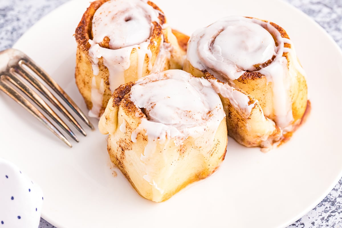 three cinnamon rolls on a plate