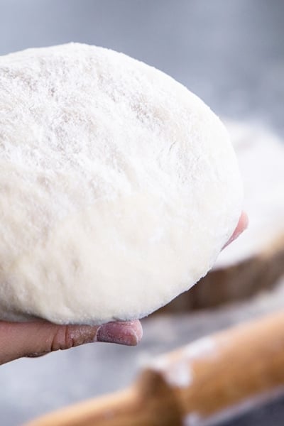 hand holding a dough ball