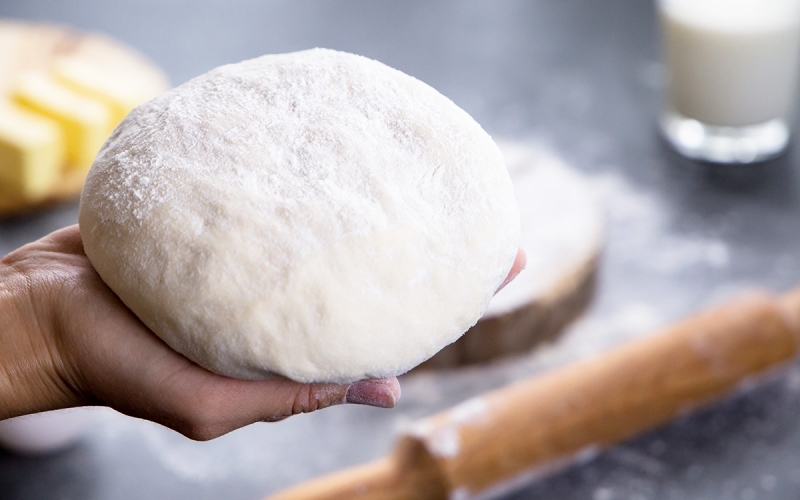 hand holding a dough ball