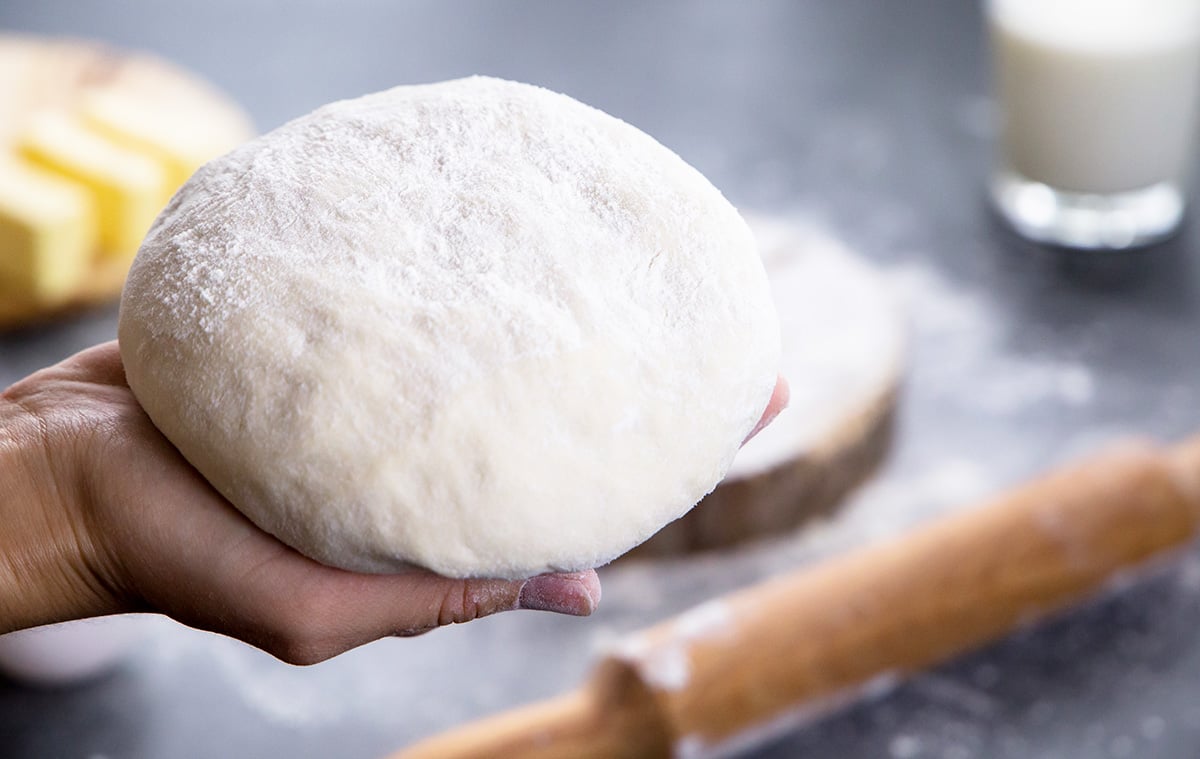 hand holding a dough ball