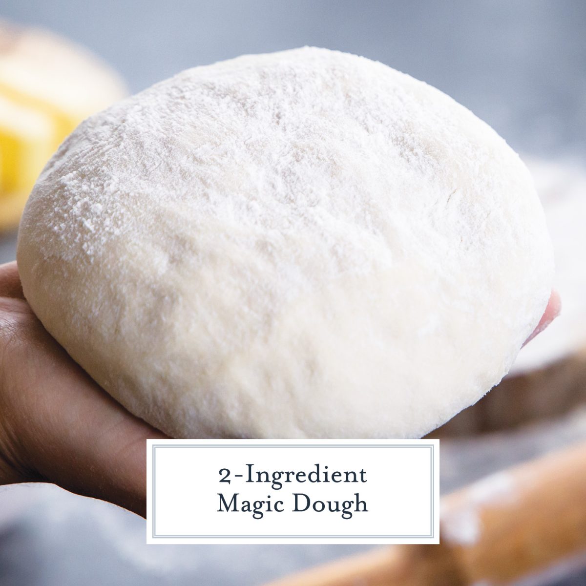 hand holding a ball of dough with flour 