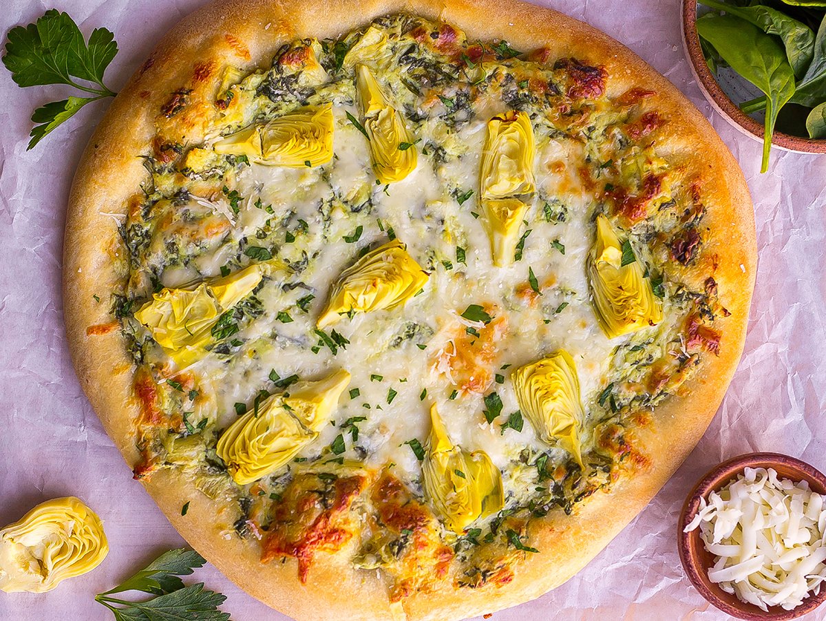 overhead shot of spinach artichoke dip pizza