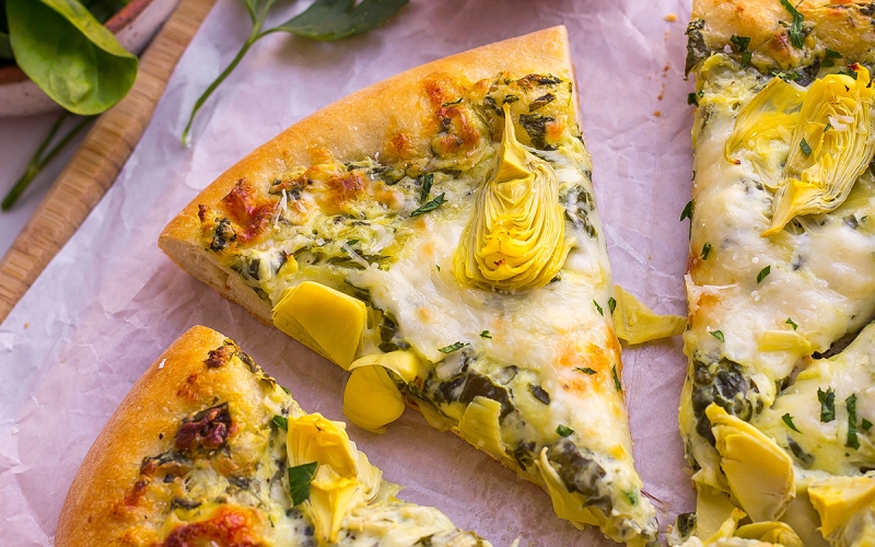 one slice of spinach artichoke pizza
