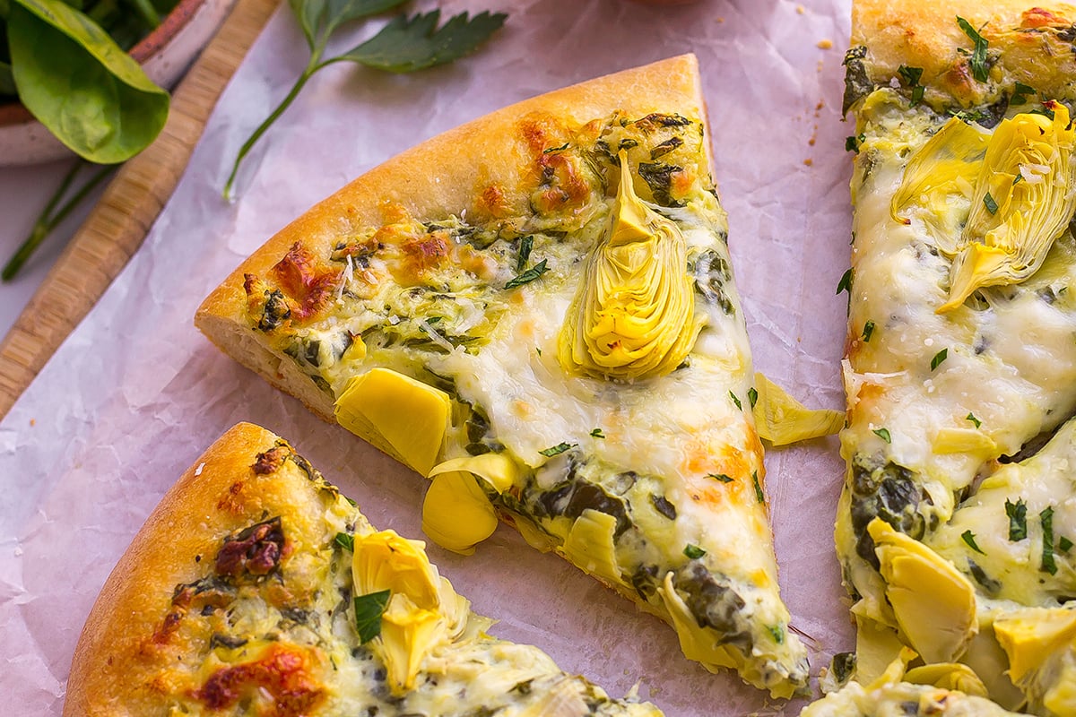 one slice of spinach artichoke pizza