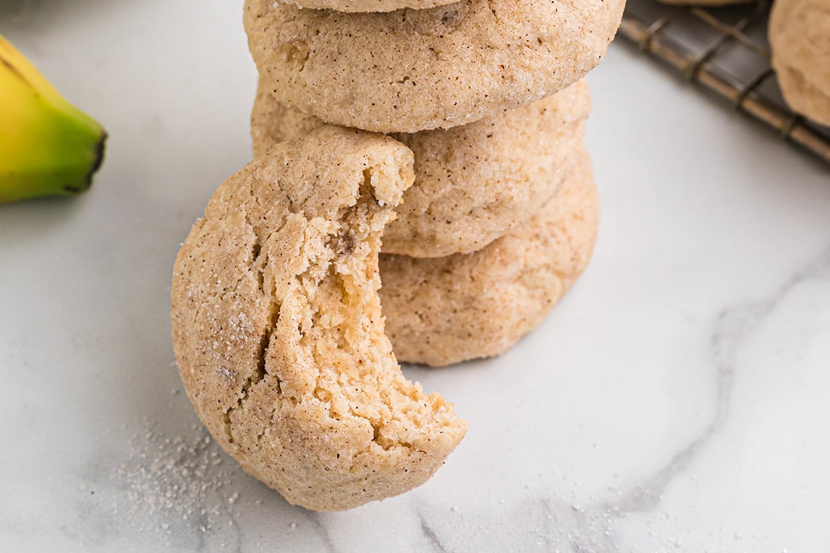 half eaten cookie propped up against a stack of cookies 