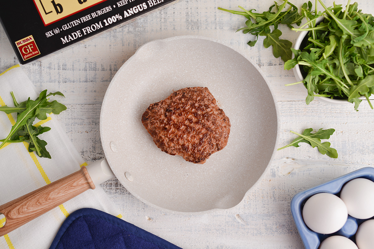 single burger in a white skillet 