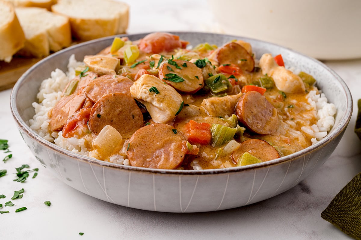 angle view of gumbo in a bowl with parsley topping 