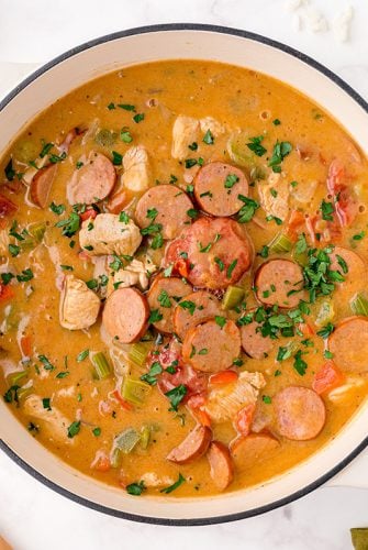overhead bowl of chicken and sausage gumbo in a white bowl