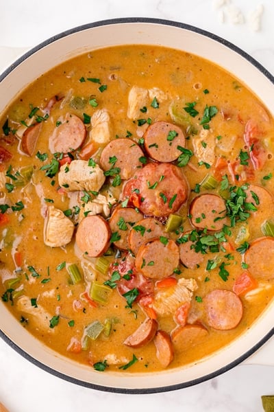 overhead bowl of chicken and sausage gumbo in a white bowl