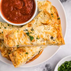 garlic bread spread on bread with marinara dipping sauce