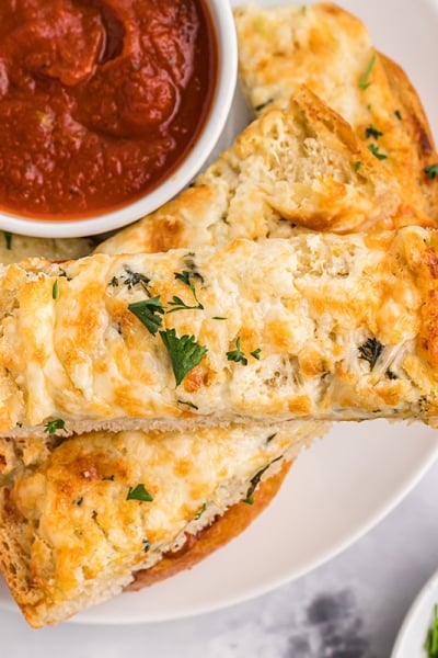 garlic bread spread on bread with marinara dipping sauce