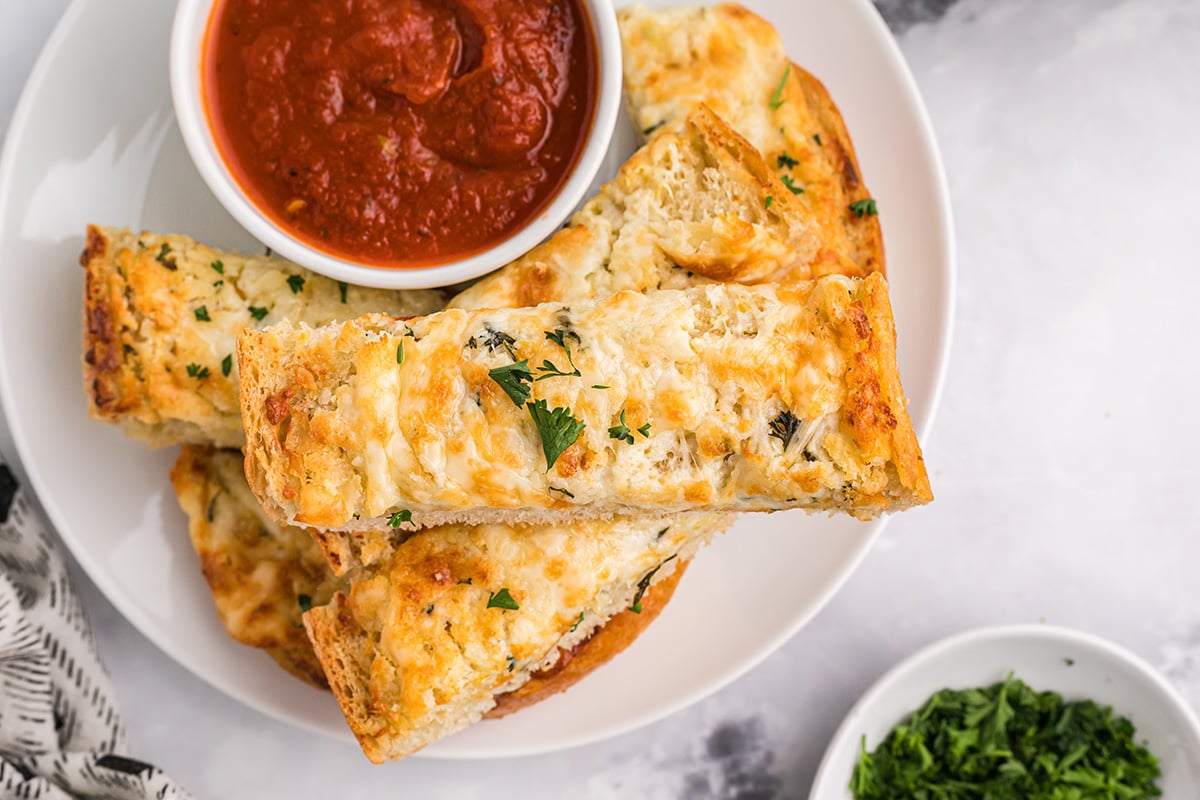 garlic bread spread on bread with marinara dipping sauce