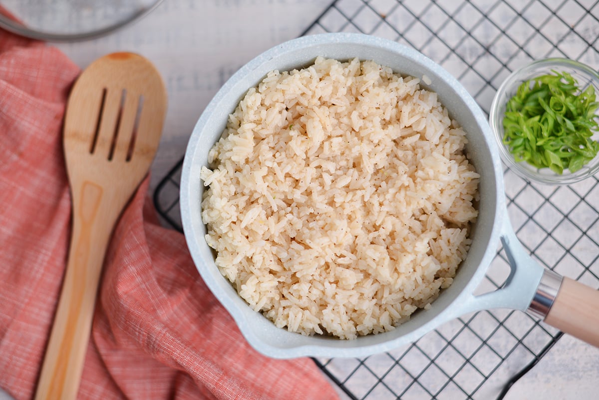 overhead of ginger rice in a blue saucepan 