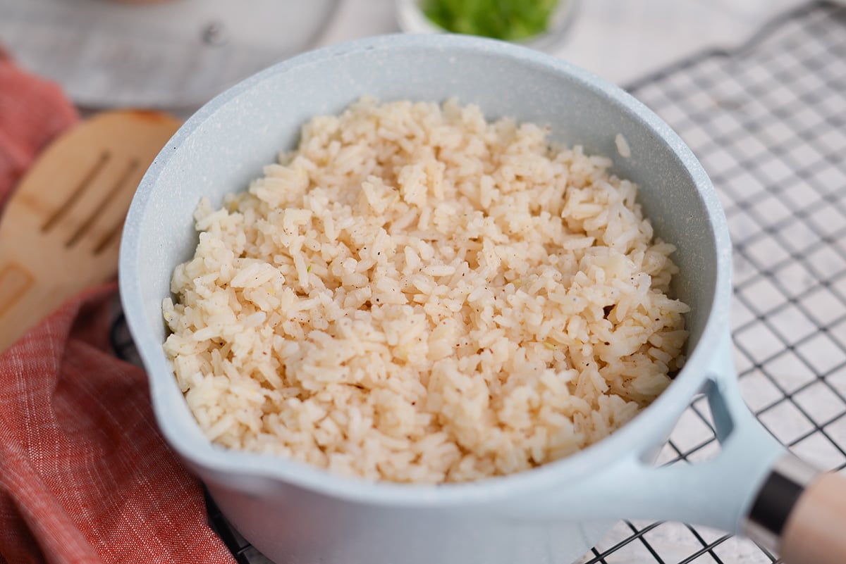 angle of ginger rice in a blue saucepan with red linen 