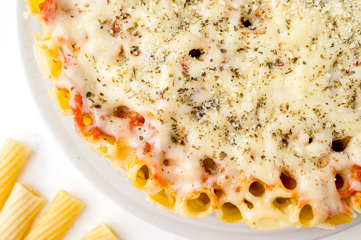 close up overhead of melted cheese on honeycomb pasta