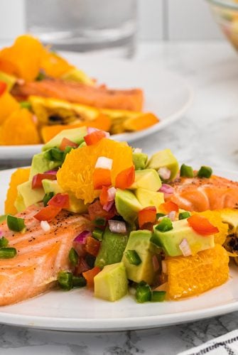 citrus salmon on a plate with orange slices