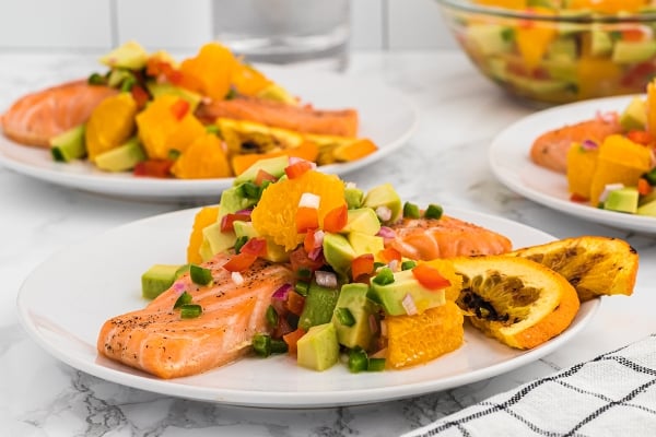 citrus salmon on a plate with orange slices