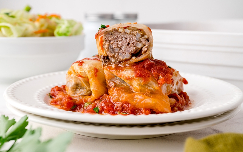 half a cabbage roll stacked on two cabbage rolls