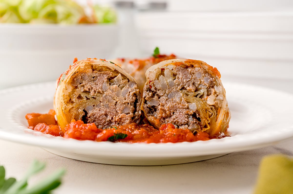 cabbage roll cut in half on a white plate