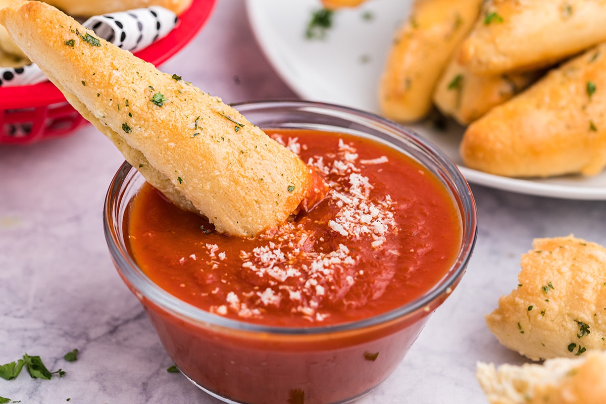 breadstick dipping into marinara sauce