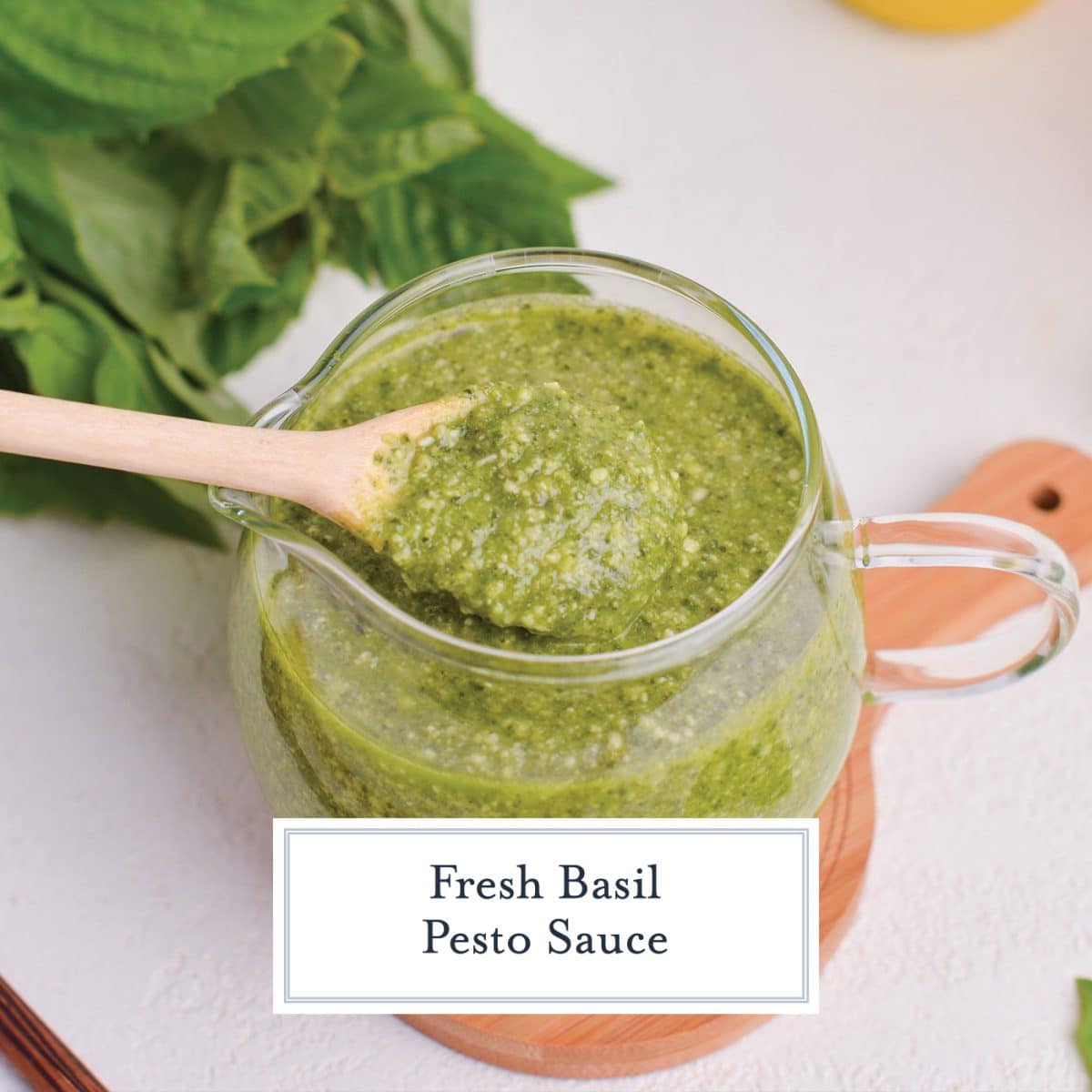 wooden spoon in jar of basil pesto sauce with text overlay for facebook