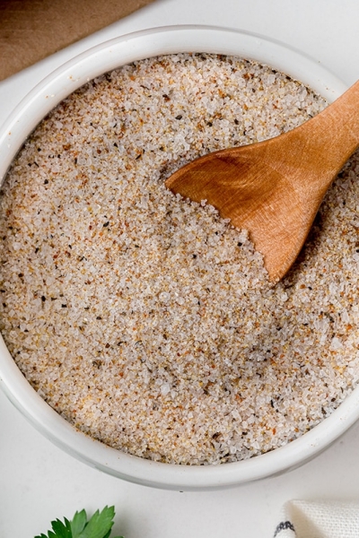 wooden spoon in bowl of steak seasoning