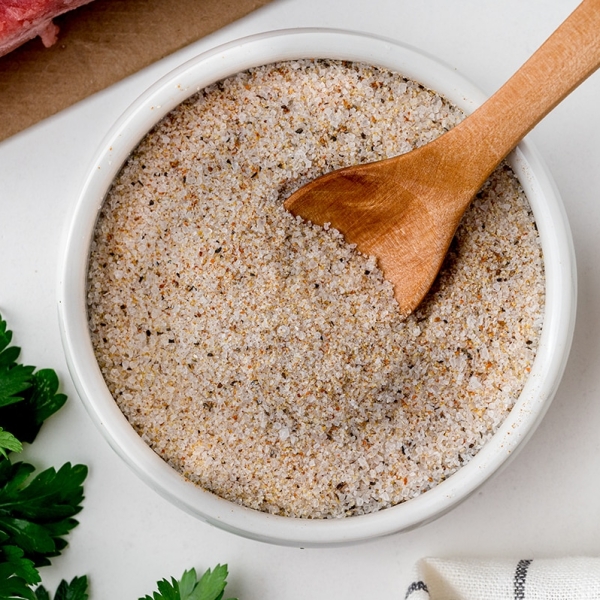 wooden spoon in bowl of steak seasoning