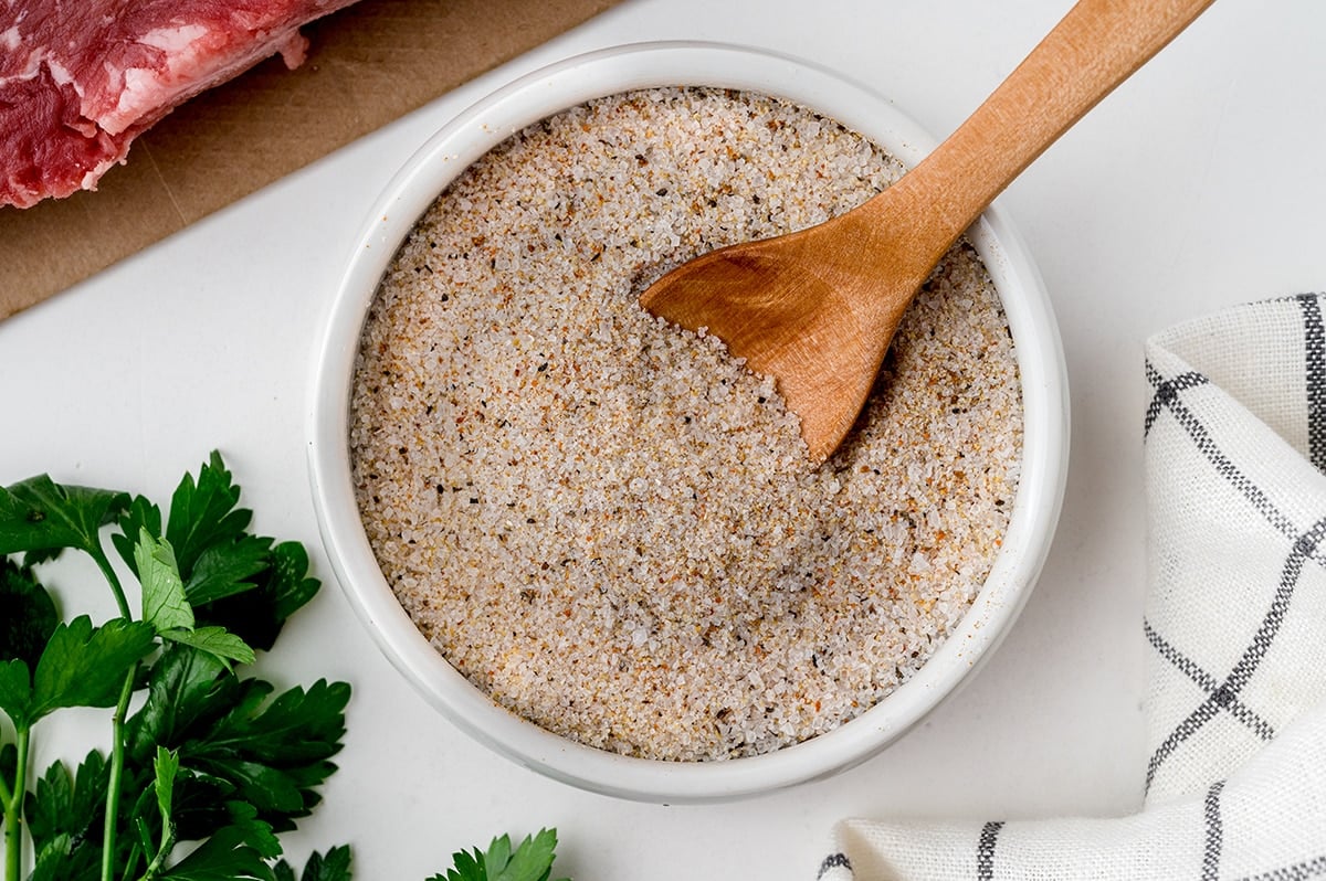 wooden spoon in bowl of steak seasoning