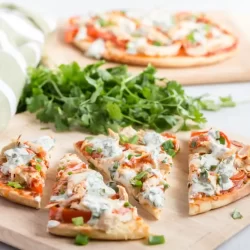 butter chicken flatbreads on a cutting board