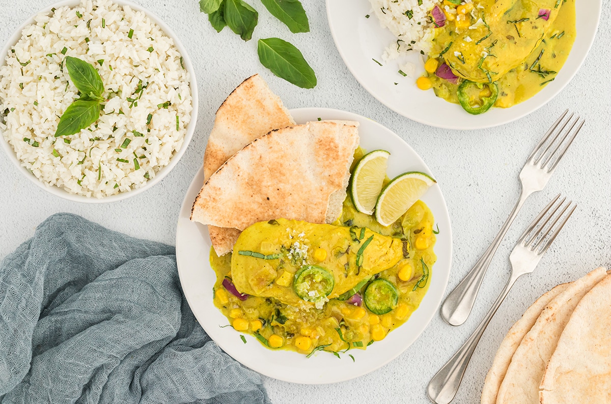 overhead shot of coconut chicken curry on a plate with flatbread