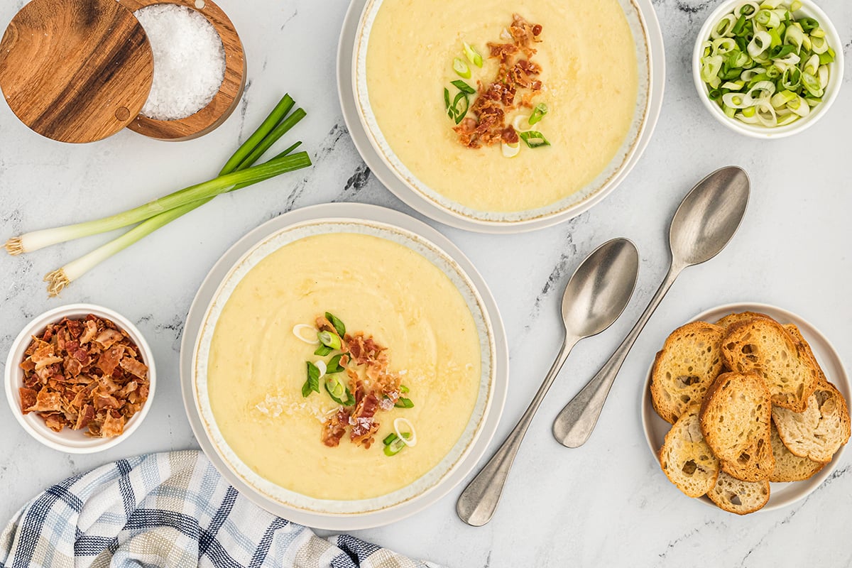 overhead shot of two bowls or leek and potato soup
