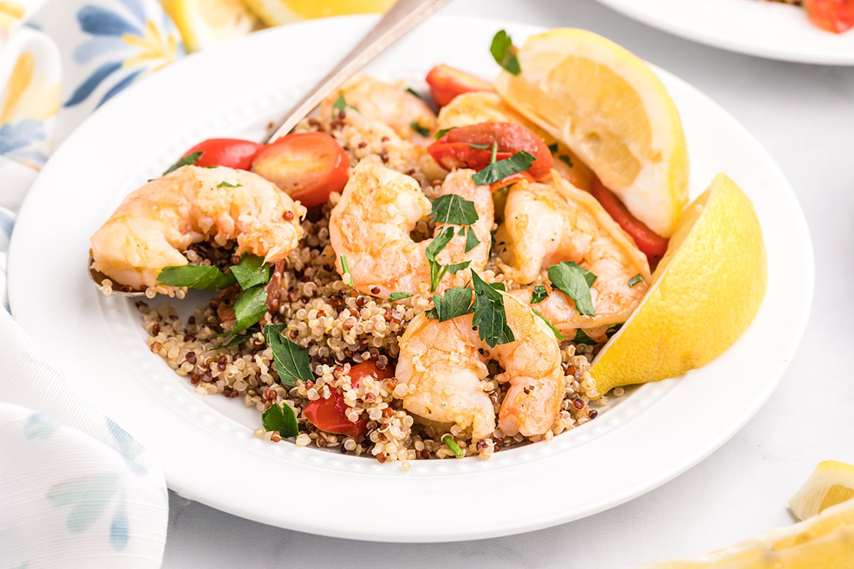 plate of garlic butter shrimp with lemons 