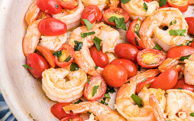 close up of garlic butter shrimp with tomatoes