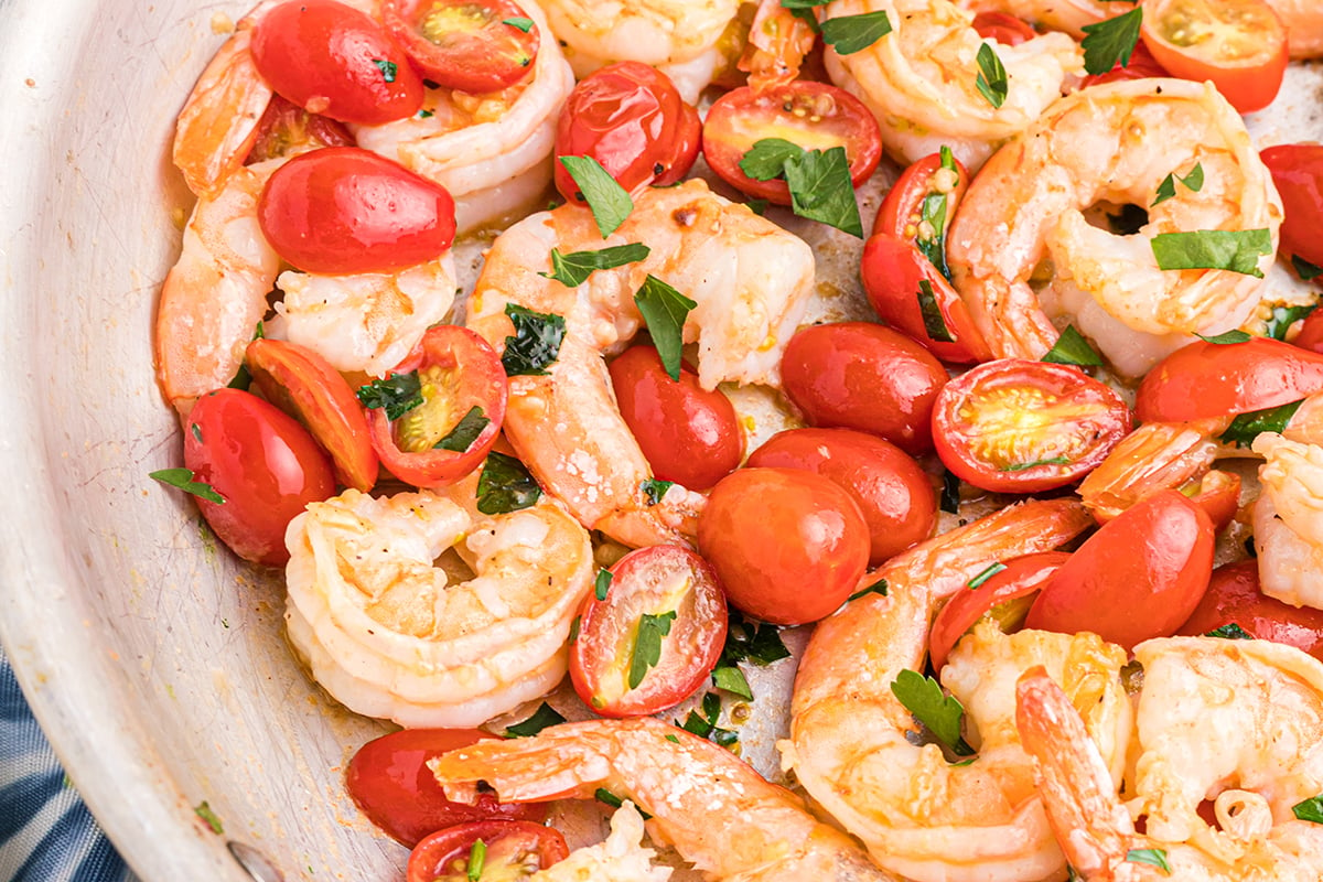 close up of shrimp and tomatoes in a skillet 