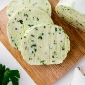 sliced of flavored butter on a wood cutting board